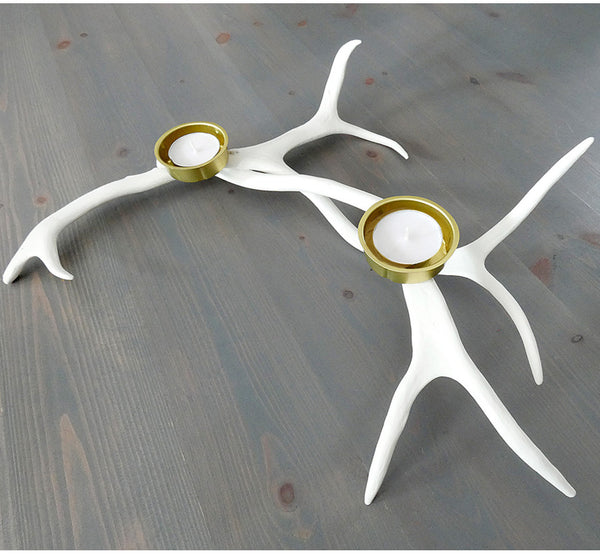 Handmade white reindeer antler tealight candle holder, 40x40 cm, 15.75x15.75", on gray wooden table.