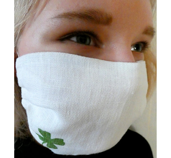 Women wearing handmade double layer face mask, 100% linen fabric, white with hand printed green clover figure, face cover .